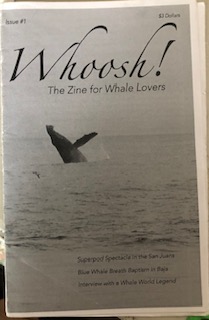 Grey cover with a picture of a whale. 