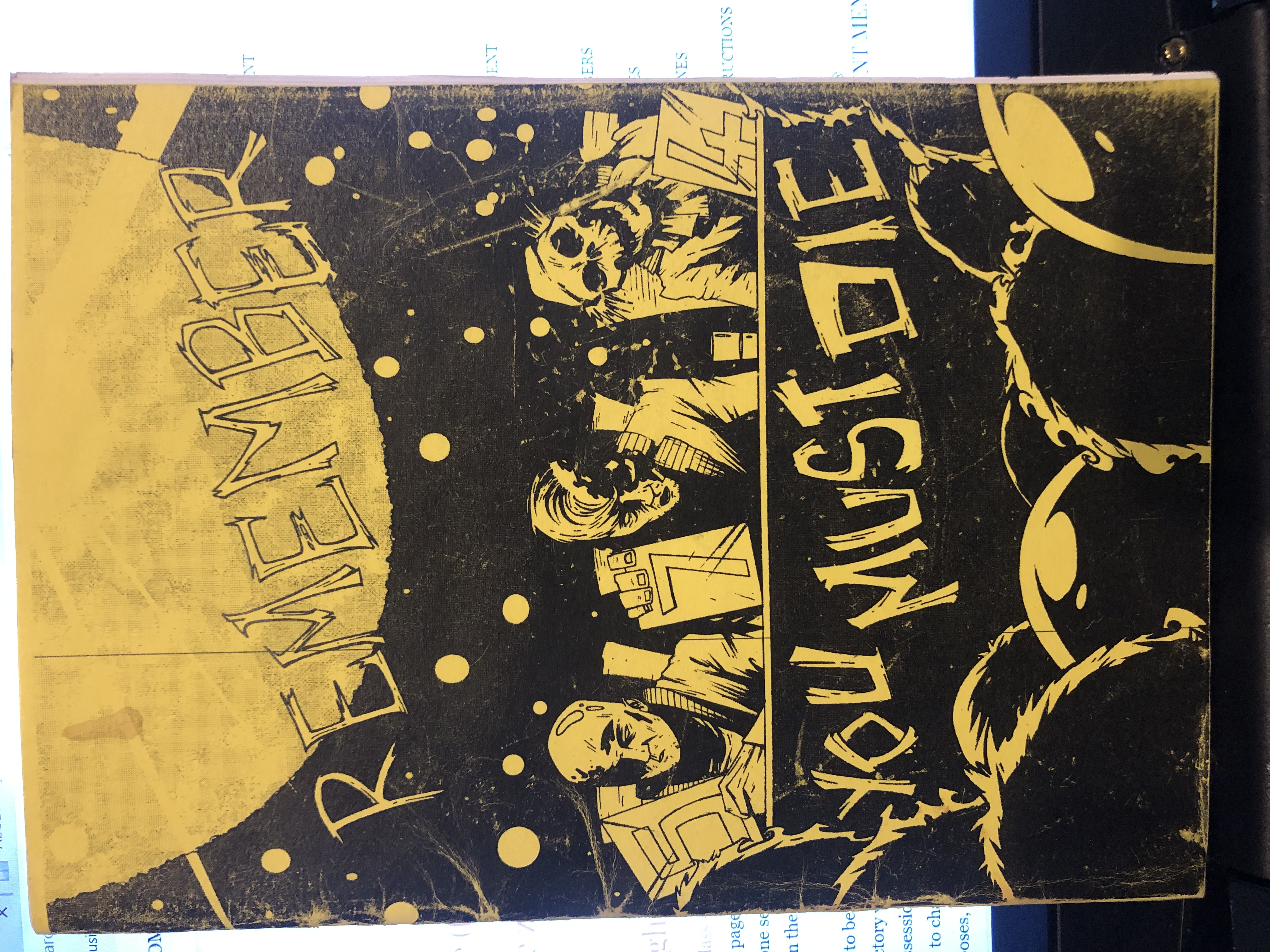 Black and yellow duotone cover, three figures hold up rating cards reading 5, 7, and 4 from left to right.
