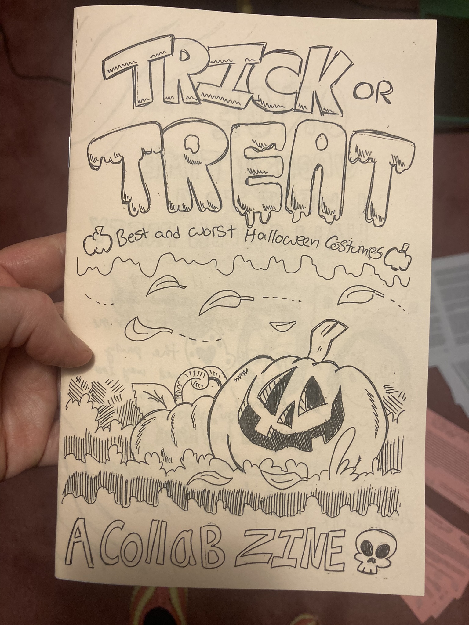 The zine cover has the title of the zine and a picture of a carved pumpkin in a pumpkin patch