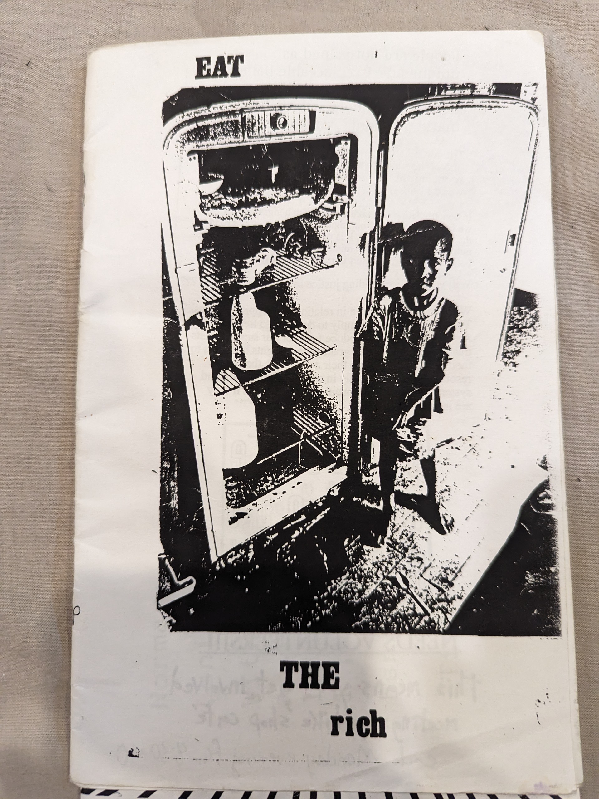 A very blurry kid standing by an 1960s open fridge