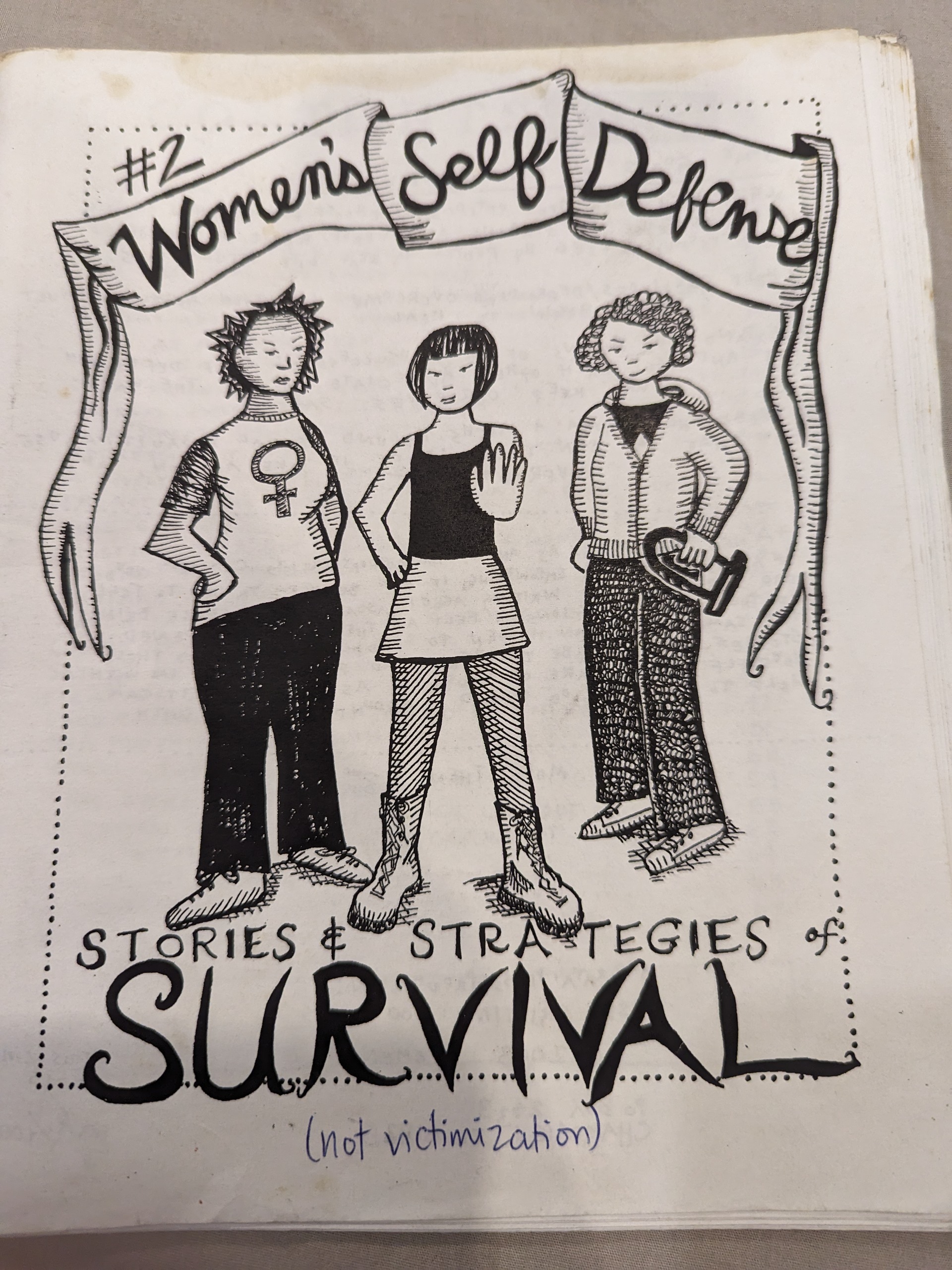 Three women standing underneath a banner that says "Women's Self Defense"