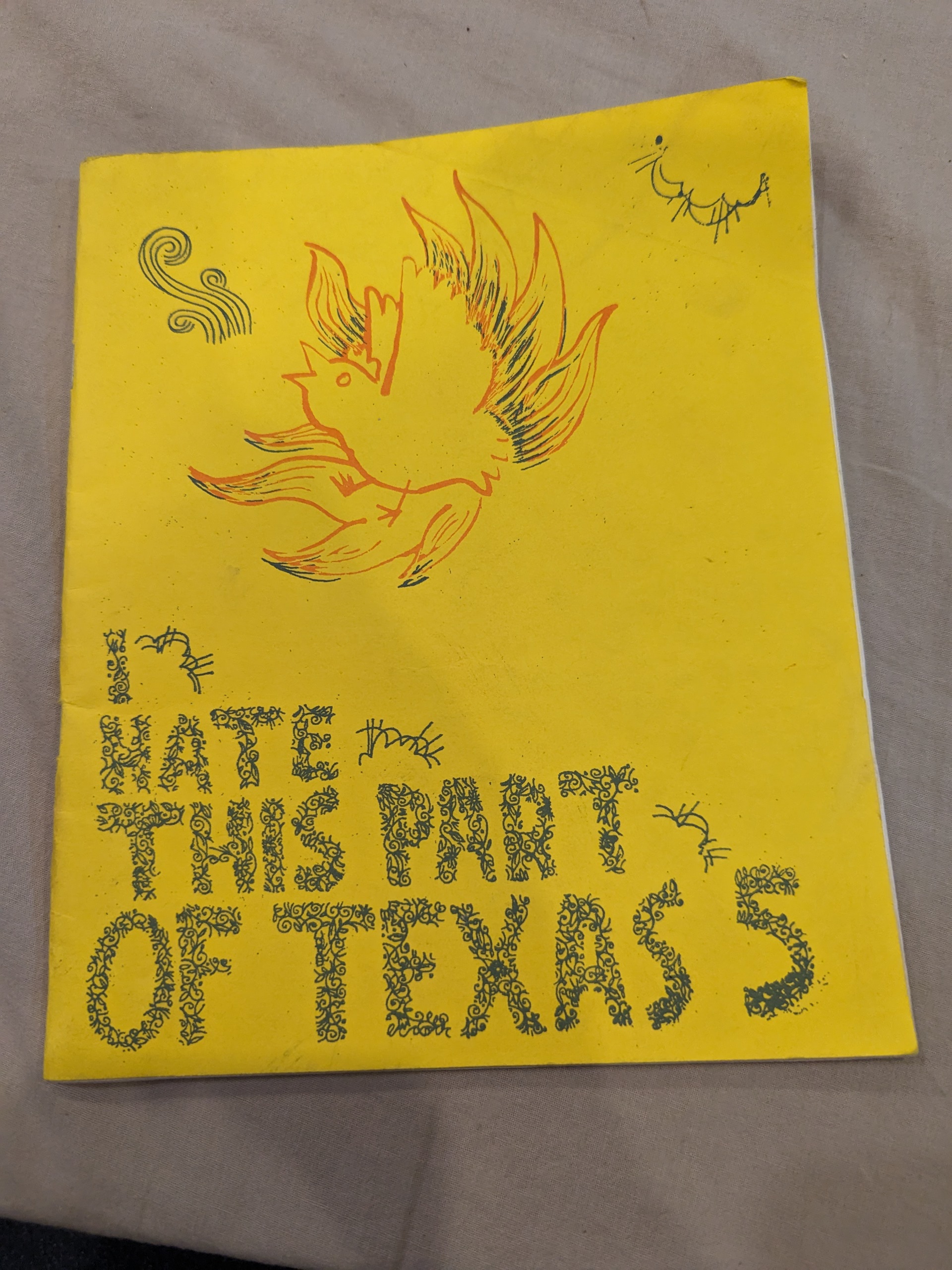 Half-page, yellow silk screened cover with a chicken on fire adorning the top half of the cover.