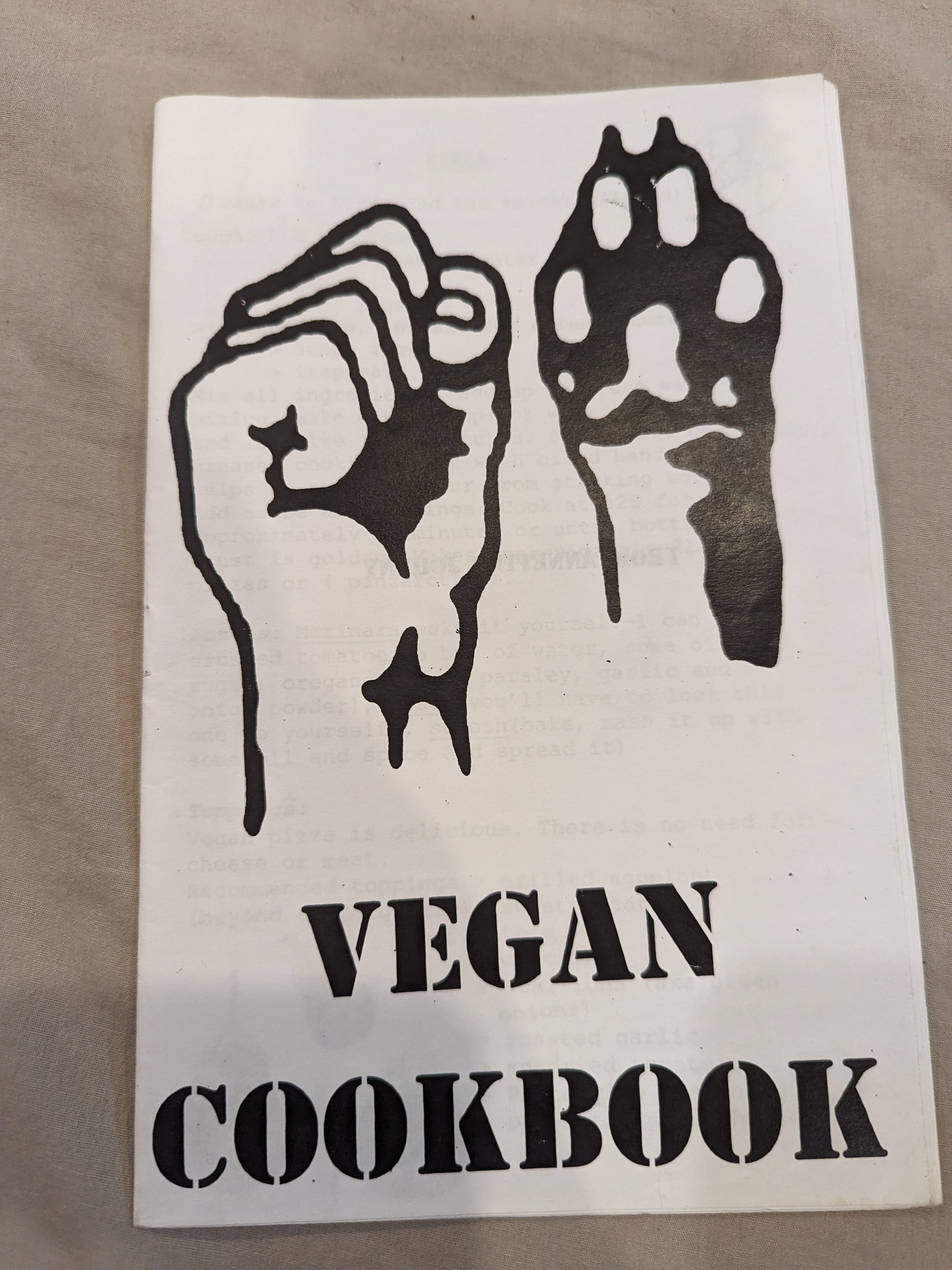 A fist and a paw adorn the cover, along with the title "Vegan Cookbook"