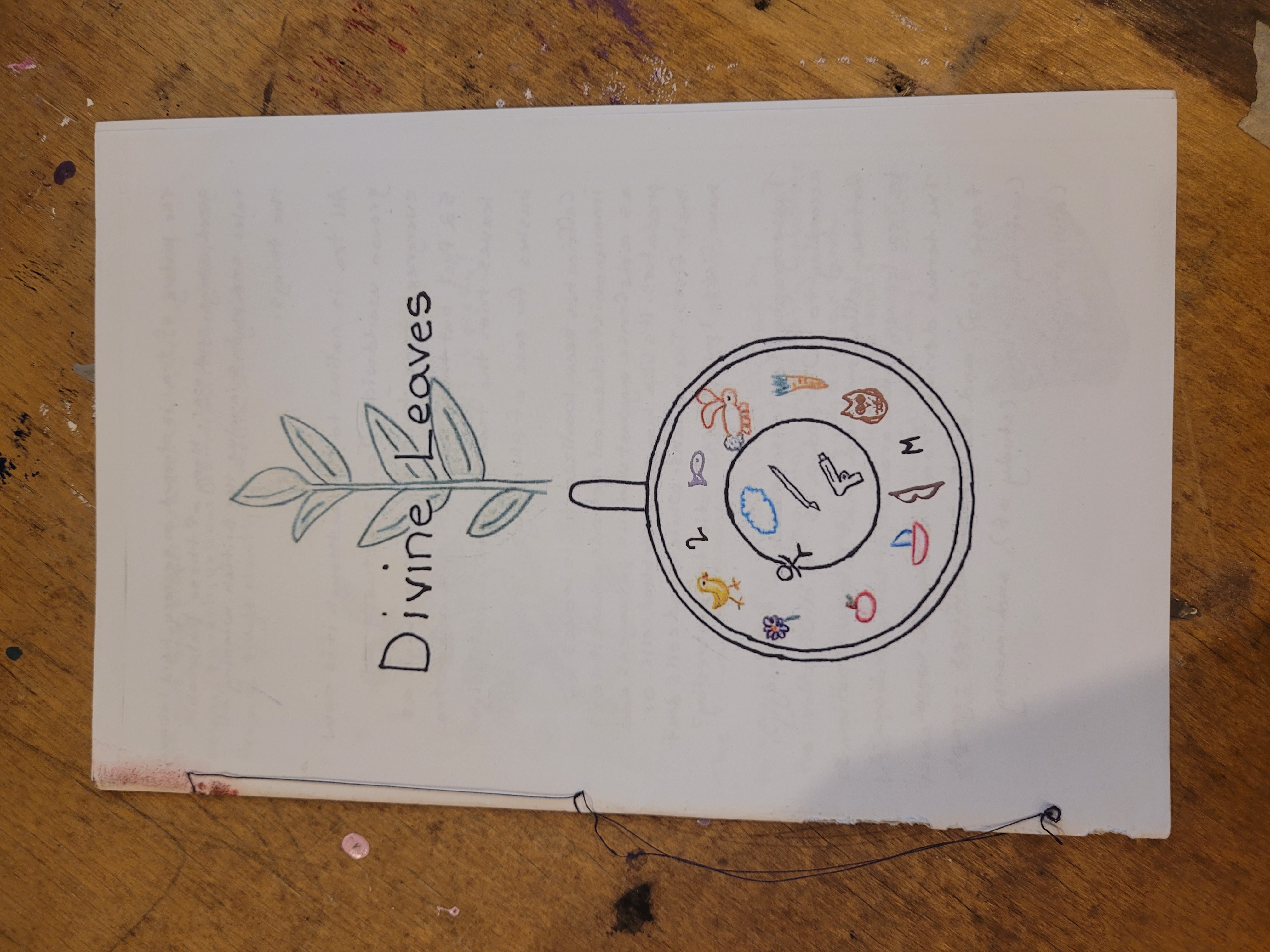 Half-page zine with white paper cover. Hand-written title "Divine Leaves" with drawing of a mug and plant growing from behind. 