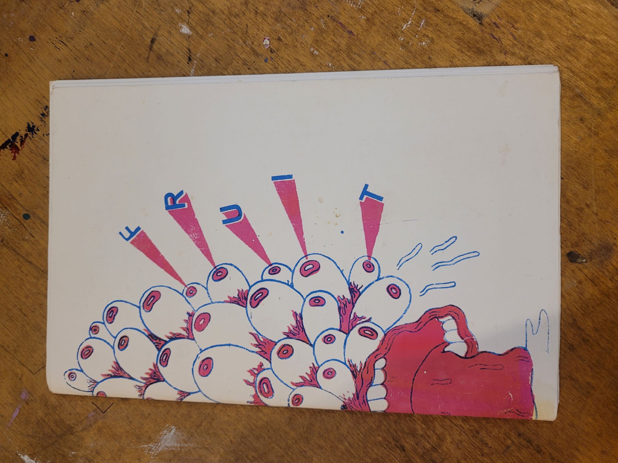 Colourful monster with a ton of eyes and the letters of "Fruit" shooting out of them.