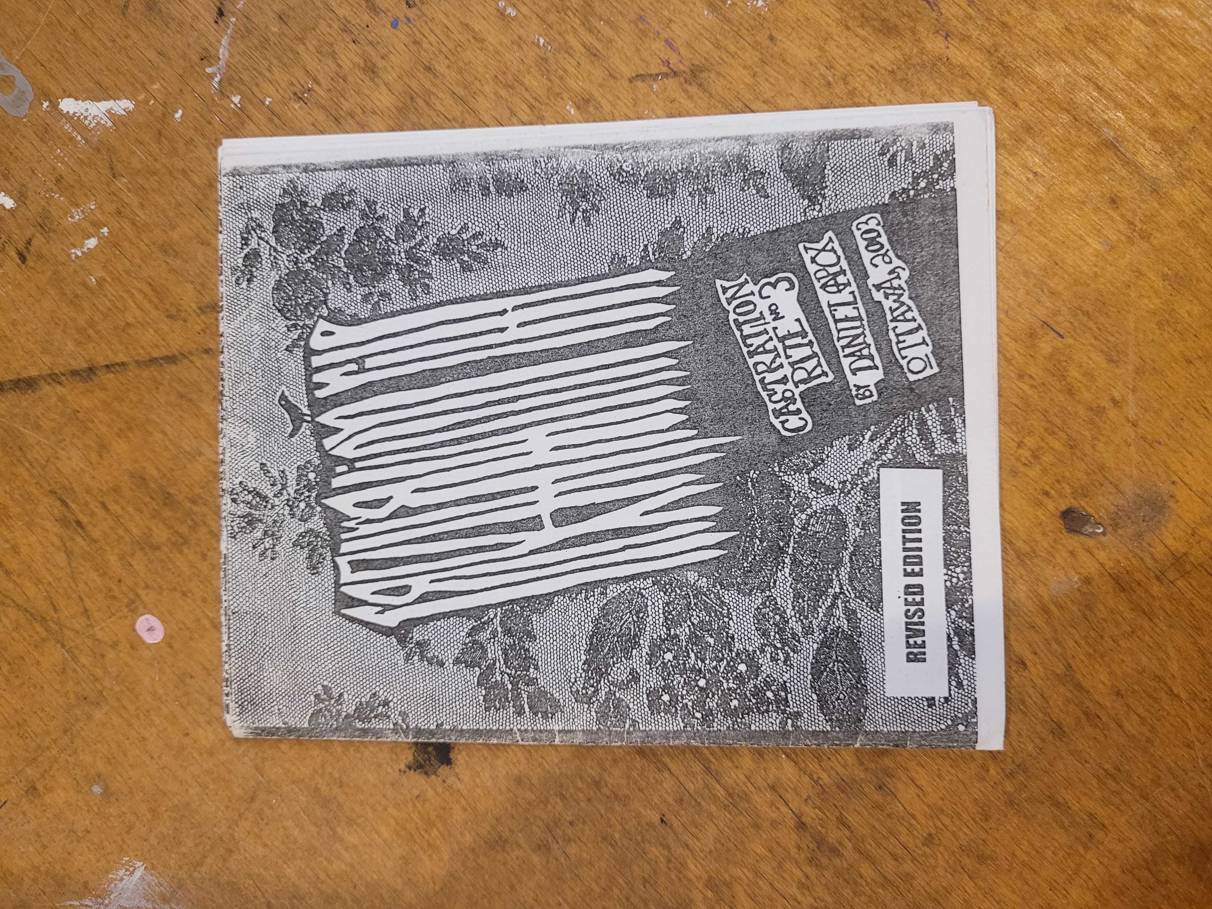 5" x 4" black and white zine on wooden table